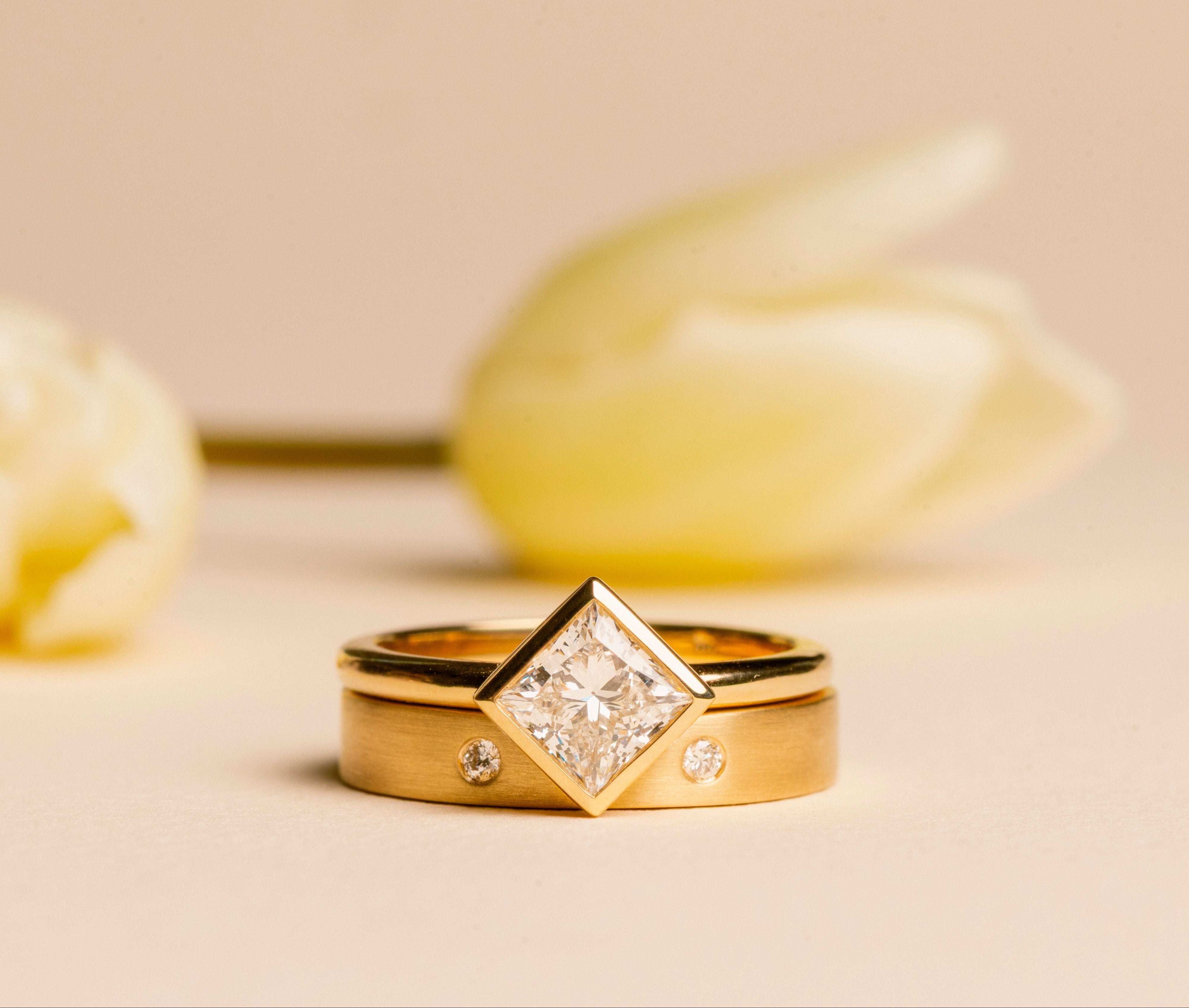 Gold rings with a diamonds on a beige background