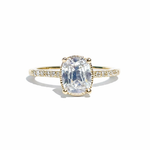 Gold ring with a large diamond and smaller diamonds on the band against a white background