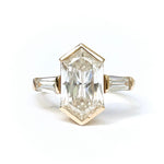 Gold ring with a large rectangular diamond on a white background