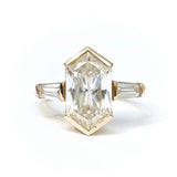 Gold ring with a large rectangular diamond on a white background