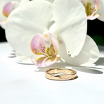 Gold ring on a white orchid flower