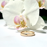 Gold ring on a white orchid flower