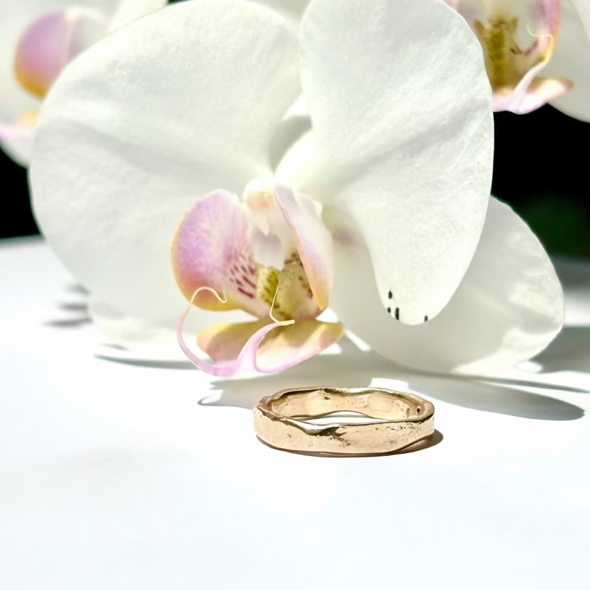 Gold ring on a white orchid flower