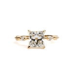 Gold ring with a large diamond and smaller diamonds on a white background