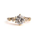 Gold ring with a large diamond on a white background