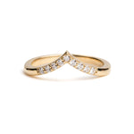 Gold ring with embedded diamonds on a white background