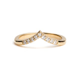 Gold ring with embedded diamonds on a white background